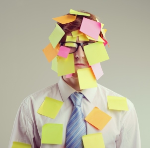 Man with post-it notes stuck on face and body